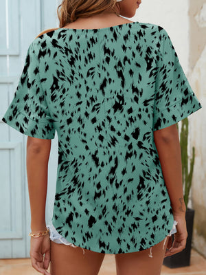 Relaxed notch neck top in turquoise with black dalmatian print and short sleeves.