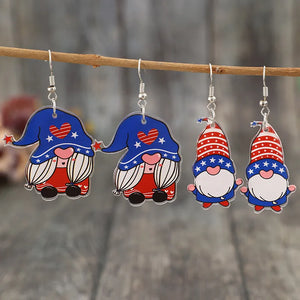 Patriotic gnome acrylic dangle earrings in royal blue with red and white star patterns.
