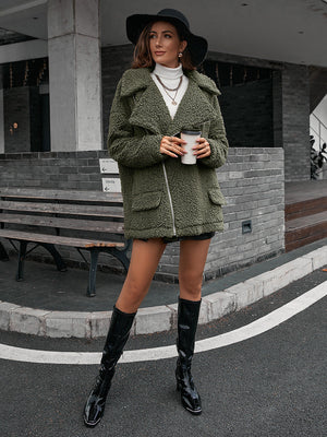 Green teddy moto jacket with asymmetrical zip and collared neckline.