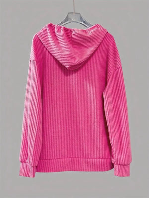 Fuchsia pink ribbed knit hoodie with drawstring and button-front detail.
