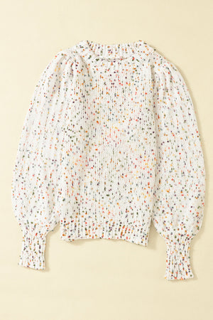 Speckled puff sleeve knit sweater in cream with colorful flecks, crew neck, and ribbed cuffs.