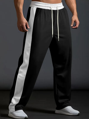 Black track pants with white side panel detail and drawstring waist.