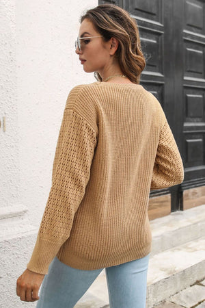 Camel open-knit sleeve crewneck sweater made of 100% acrylic with ribbed details.