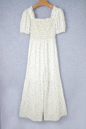 White floral smocked bodice wide-leg jumpsuit with puff sleeves.