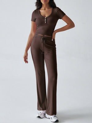 Brown button-front crop top and flared lounge pants with drawstring waist.