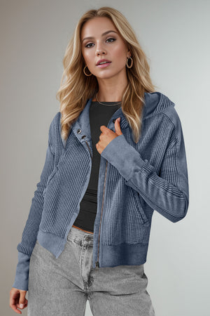 Textured knit bomber hoodie in dusty blue with a zip front and hood.