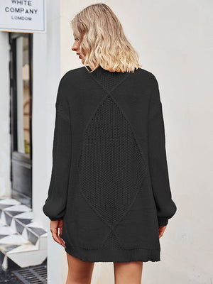 Black cable knit longline cardigan with diamond pattern detail on back.