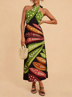Tropical print halter neck midi dress with green polka dot and leaf patterns.