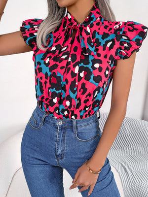 Hot pink leopard print blouse with ruffled sleeves and pussybow tie neckline.