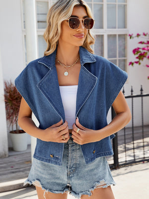 Denim double-breasted sleeveless jacket in dusty blue with a notched collar and button details.