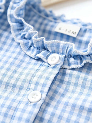Baby dress in pastel blue gingham with white ruffled neckline and button front.