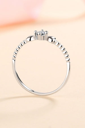 Silver ring with heart motif and moissanite stone