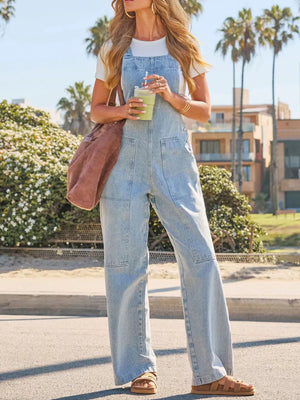 Light wash denim overalls with wide legs and utility pockets.