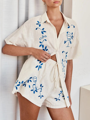 Cream linen co-ord set with blue floral embroidery and 'Ciao' text.