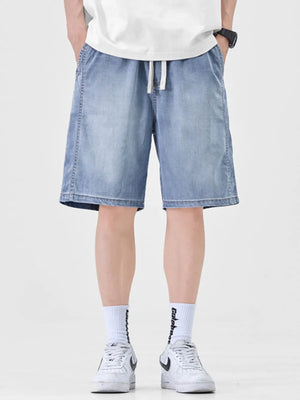 Light blue denim shorts for men with drawstring waist and loose fit.