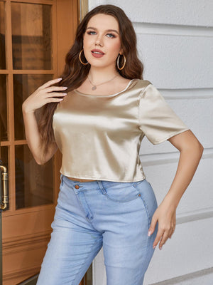 Gold satin backless blouse with short sleeves and a bow-tie detail at the back.