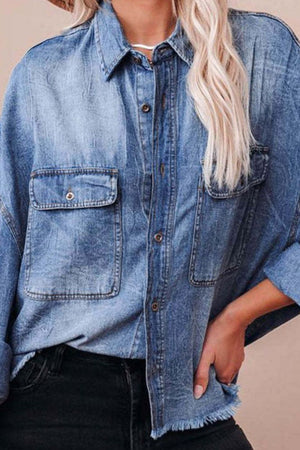 Light wash denim oversized shirt with raw hem and chest pockets.