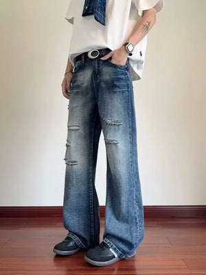 Distressed wide-leg men's jeans in blue denim with ripped details and pockets.