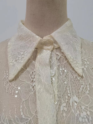 Apricot lace dress with floral pattern, sequins, and ruffled hem detail.
