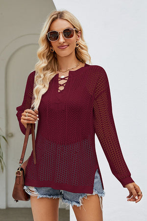 Burgundy lace-up openwork knit tunic with long sleeves and a V-neck.