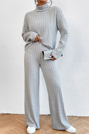 Light gray ribbed knit turtleneck loungewear set with wide leg pants.