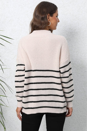 Beige striped knit sweater with black horizontal stripes on sleeves and lower body.