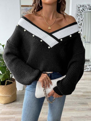 Black ribbed knit V-neck sweater with pearl trim and white stripe detail