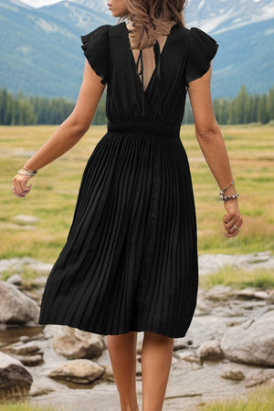 Black pleated flutter sleeve dress with smocked waist and tie back detail.