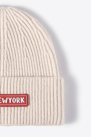Beige ribbed acrylic beanie with New York patch detail