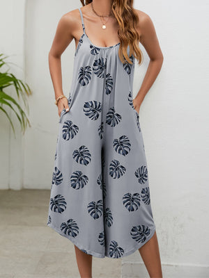 Gray Dawn culotte jumpsuit with monstera print, gathered bust, and spaghetti straps.