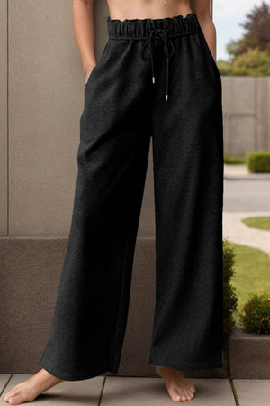 Black relaxed palazzo lounge trousers with drawstring waist and wide legs.