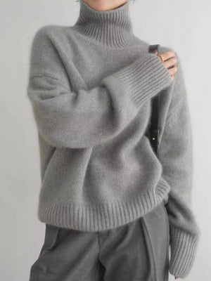 Gray acrylic turtleneck sweater with dropped shoulders and ribbed cuffs and hem.