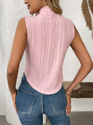 Textured sleeveless mock neck top in blush pink with vertical crinkle detail