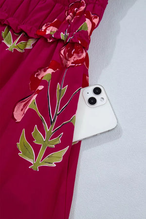 Charming floral tiered midi dress in magenta with a pocket holding a white smartphone.