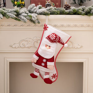 Plush Santa Christmas stocking with red knit sweater and snowflake hat, hanging on mantel.