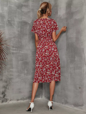 Wine red midi dress with a vibrant leaf pattern, V-neck, short sleeves, and an A-line cut.