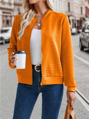Quilted bomber jacket in Tangerine with zip closure and ribbed cuffs.