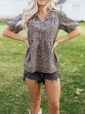 Leopard print V-neck denim top with drawstring and short sleeves.