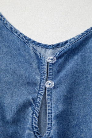 Medium wash denim romper with V-neck and button detail