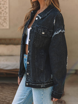 Black denim trucker jacket with raw hem and distressed details.