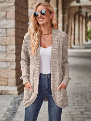 Tan textured ribbed open-front cardigan with pockets, styled with a white tank and jeans.