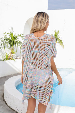 Open-knit pastel beach cover-up with V-neck and short sleeves, featuring tassel ties.