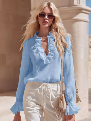 Sky blue maternity shirt with V-neck ruffles and flared cuffs.