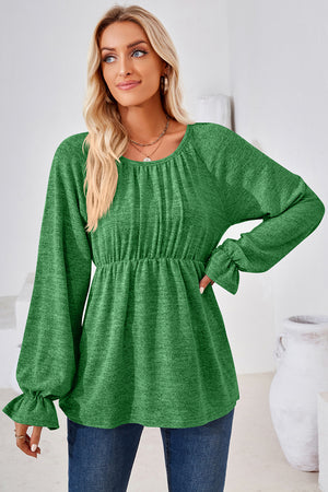 Green peasant blouse with gathered neckline, elastic waist, and ruffled bell sleeves.