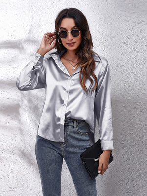 Silver satin finish button-up shirt with effortless drape, collared neckline, and button cuffs.