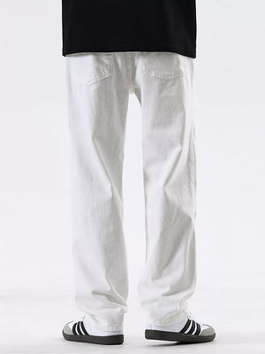 Men's white cotton jeans with a relaxed fit and pocketed design.