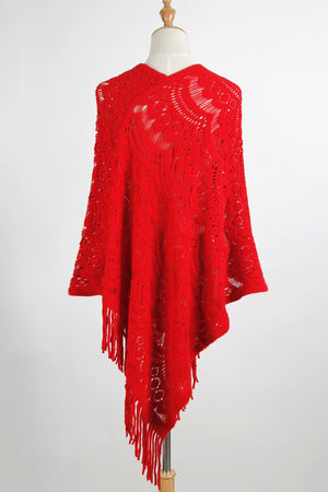 Red crochet poncho with intricate lace pattern and fringe details