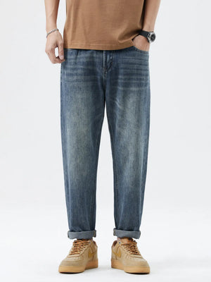 Men's blue washed stretch denim jeans with a relaxed fit and cuffed hems.