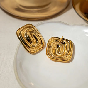 Gold sculpted swirl square earrings with a contemporary, chic design.