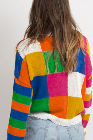 Patchwork knit crewneck pullover sweater in bold color blocks and stripes.